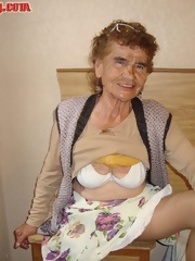 Dressed grandmother shows tits