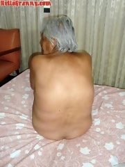 Maxican grandmother posing in bed